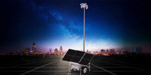 A solar-powered security camera trailer system in an empty lot at night, with a city skyline in the background. The trailer features large solar panels and a tall, extendable pole with multiple security cameras for remote surveillance.